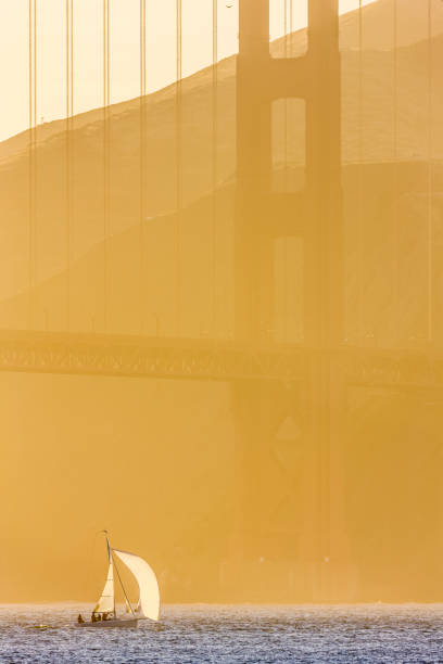 The Golden Gate Bridge in San Francisco California in late afternoon golden light seen from the Embarcadero