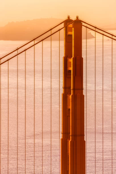 The Golden Gate Bridge in San Francisco California  with view of the Oakland Bay Bridge at sunrise