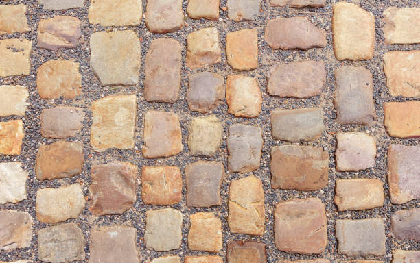 istock Old cobblestone road of big stones. 1153272552