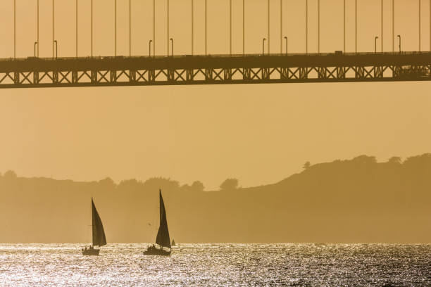 The Golden Gate Bridge in San Francisco California in late afternoon golden light seen from the Embarcadero