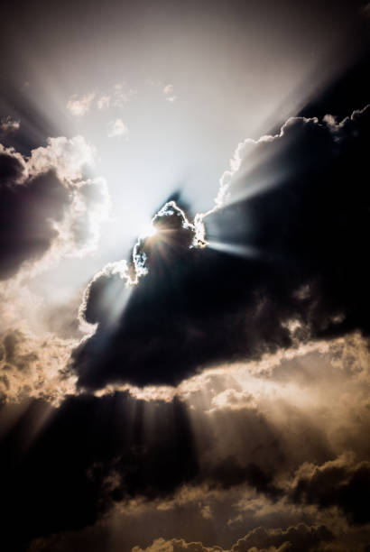 istock Light of the setting sun through the clouds 1153274344