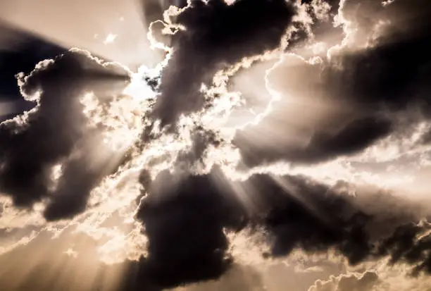 Photo of Light of the setting sun through the clouds