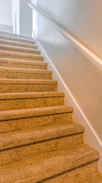 istock Vertical frame Interior of a house with a staircase covered with brown carpet 1153277169
