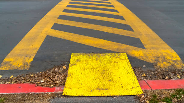 istock Panorama Yellow diagonal stripes between parallel lines painted on a paved road 1153277186