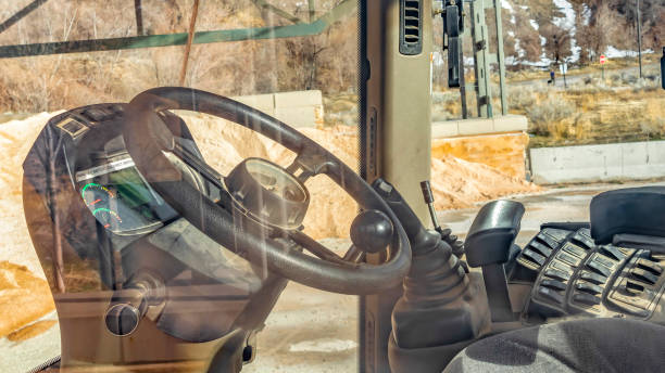 istock Panorama frame Construction vehicle cab interior with hill and sky in the sunny background 1153277257