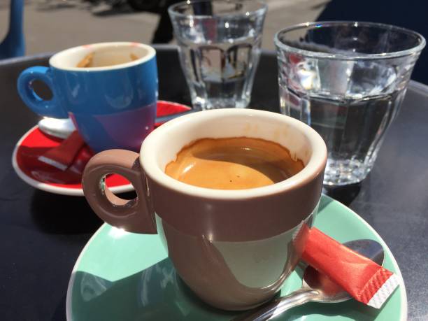 istock Espresso cup and water glass on black table 1153277306