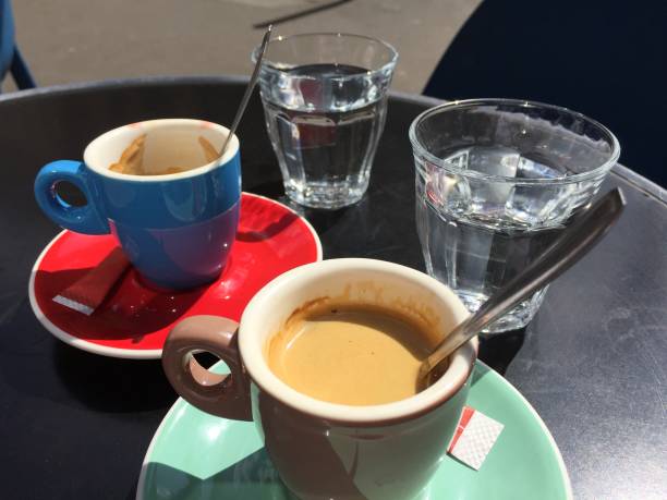 istock Espresso cup and water glass on black table 1153277316