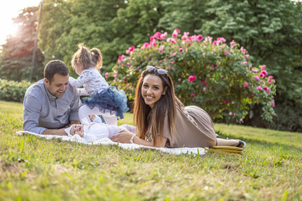 istock Young happy family enjoying spring day in nature 1153280861