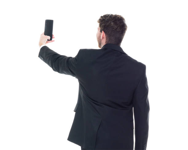 istock Young handsome businessman wearing a suit and tie - taking a selfie 1153283680