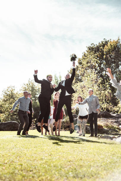 happy gay couple jumping at the wedding happy gay couple jumping at the wedding gay wedding kiss stock pictures, royalty-free photos & images