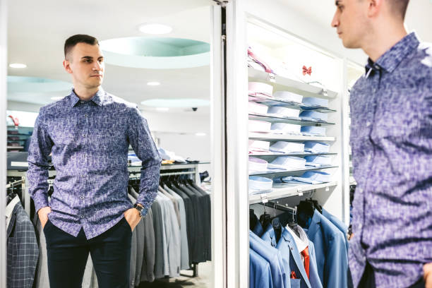 istock Man trying shirt in a store 1153285871