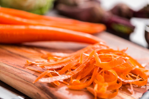 istock Peeling organic carrots to make beet soup. 1153286740