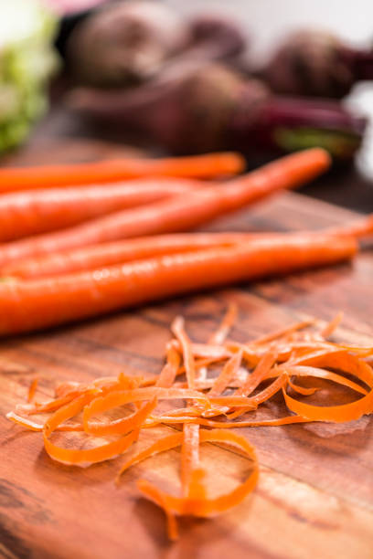 istock Peeling organic carrots to make beet soup. 1153286744