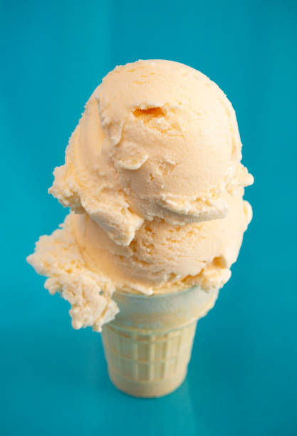 istock Double Scoop Vanilla Ice Cream Cone on a Blue Background 1153293541