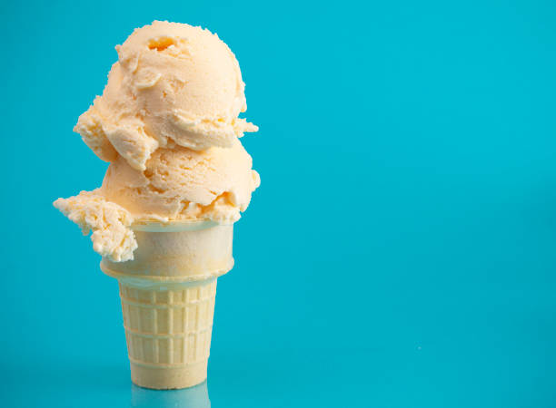 double scoop vanilla ice cream stożek na niebieskim tle - ice cream cone ice cream vanilla ice cream isolated zdjęcia i obrazy z banku zdjęć