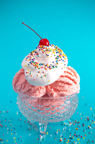 A Strawberry Ice Cream Sundae on a Bright Blue Background with a Cherry on Top