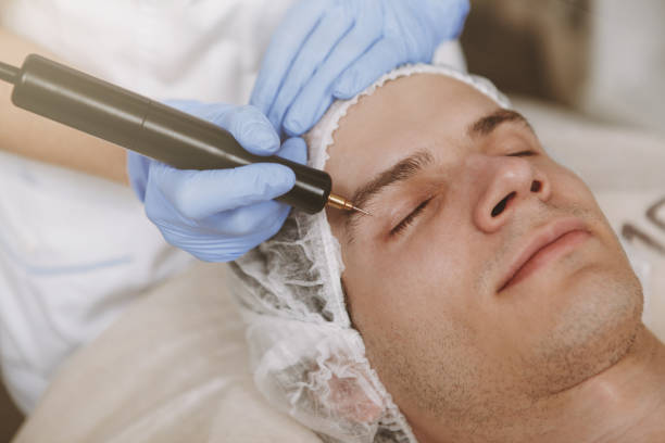 istock Young handsome man visiting cosmetologist 1153294443
