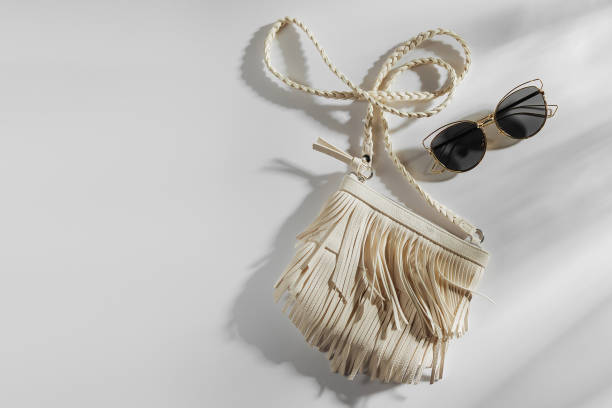 istock Small white bag with fringe and sunglass. Summer Vacation concept. 1153294490