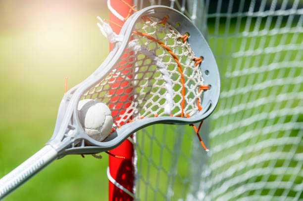 istock Abstract view of a lacrosse stick scooping up a ball. Sunny day 1153294745