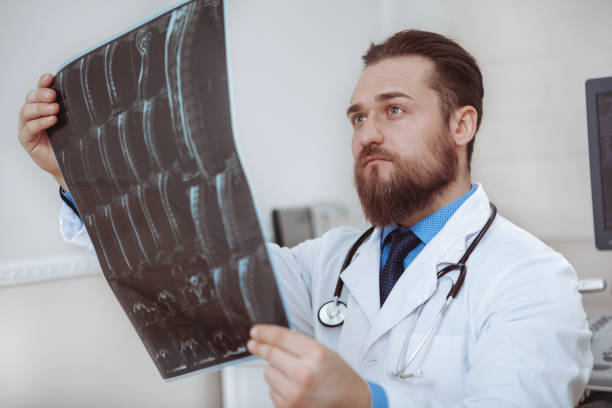 istock Bearded young doctor working at medical clinic 1153294801