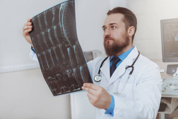 istock Bearded young doctor working at medical clinic 1153294803