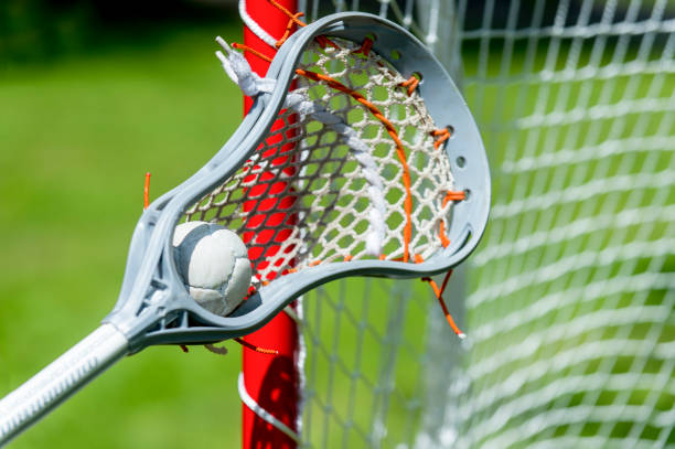 istock Abstract view of a lacrosse stick scooping up a ball 1153294973