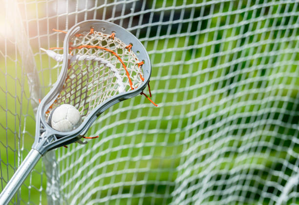 istock Abstract view of a lacrosse stick scooping up a ball. Sunny day 1153295488