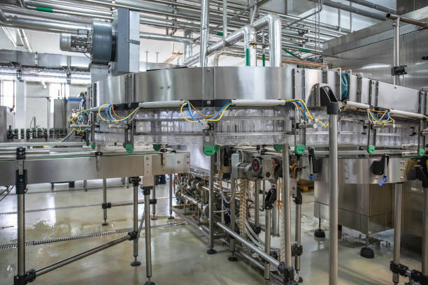 istock Empty plastic bottles move on automatic conveyor line or belt in water and juice factory or plant production 1153300096