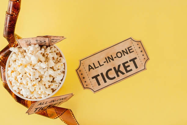 istock Movie tickets, film strips and popcorn on blue background. Copy space for text 1153302013