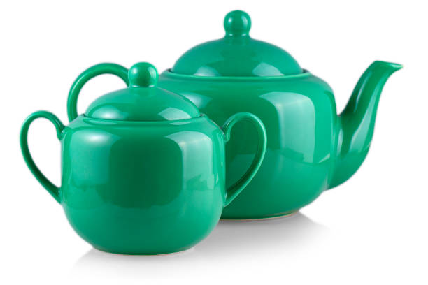 istock The green teapot and sugar bowl on white 1153302998