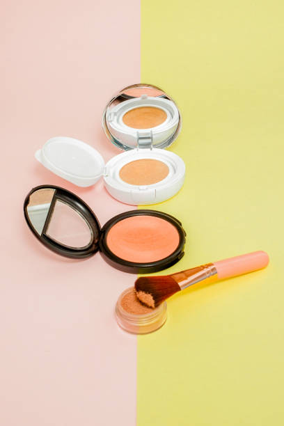 istock Make up products spilling on to a bright yellow and pink background with copy space 1153303033