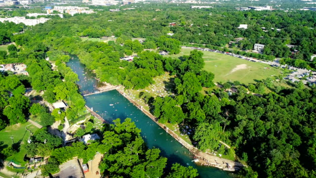 Orbiting around Huge Crowds Swimming at Barton Springs Pool in Austin , Texas