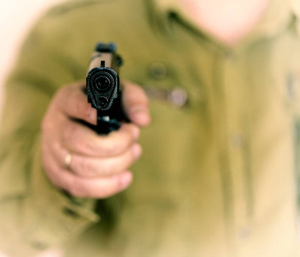 istock Man pointing gun at the target with one Hand 1153303118