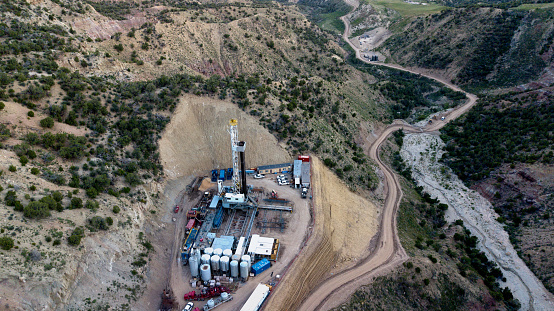 An amazing drone view of a drill rig perched on the side of a mountain in Colorado in the Springtime