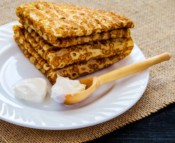 istock stack of pancakes with sour cream and wooden spoon 1153305285