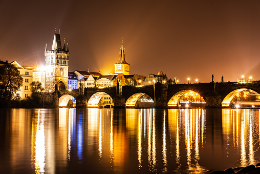 Vltava River and Charles Bridge with Old Town Bridge Tower by night, Prague, Czechia. UNESCO World Heritage Site.