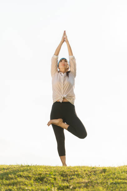 istock Mature woman practicing yoga in nature 1153306983