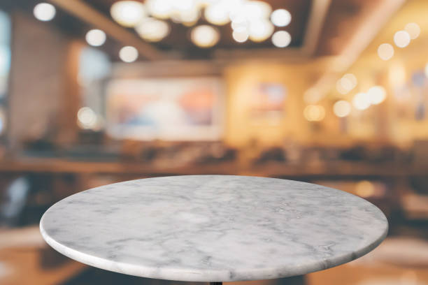 istock round marble table top with cafe restaurant bokeh lights abstract background for montage product display 1153307470