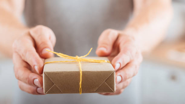 istock birthday gift man giving present wrapped paper 1153308406