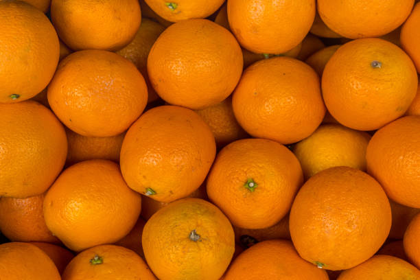 istock Closeup of oranges on a market. 1153308608