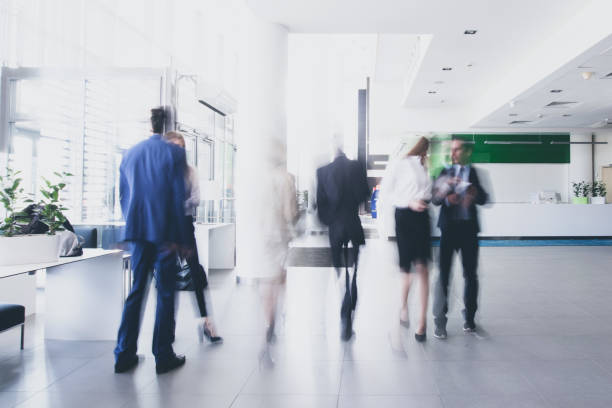 businesspeople walking in corridor - busy imagens e fotografias de stock