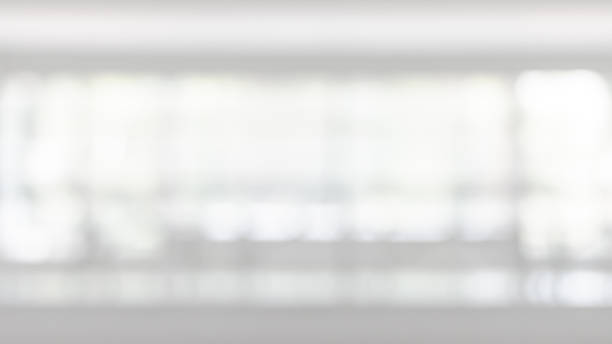 istock Blur business office background interior view empty lobby corridor hallway with glass wall white room and light bokeh 1153309772