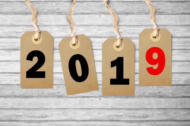 hangtags with the number 2019 on it on wooden background
