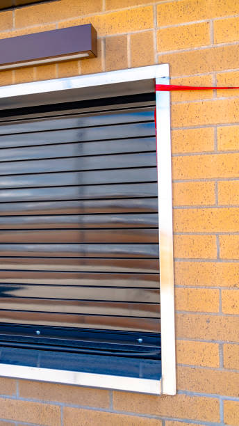 istock Vertical frame Close up of a building with glossy industrial roller shutter on the window 1153314099