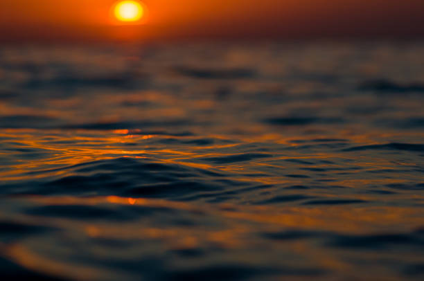 istock Amazing sea sunset on the pebble beach, the sun, waves, clouds 1153316978