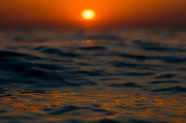 istock Amazing sea sunset on the pebble beach, the sun, waves, clouds 1153317163