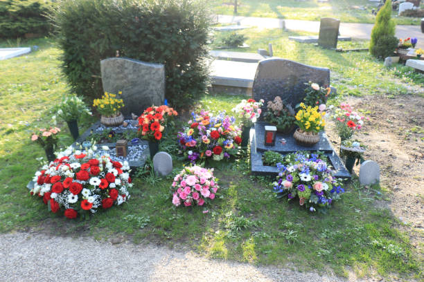 istock Funeral flowers on graves 1153317447
