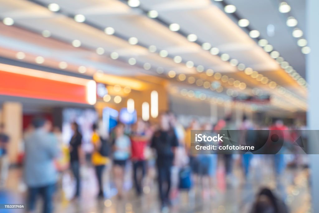 Blurred,defocused background of Crowd in trade event exhibition hall. Business trade show,shopping mall and marketing advertisement concept,MICE industry business concept Exhibition Stock Photo