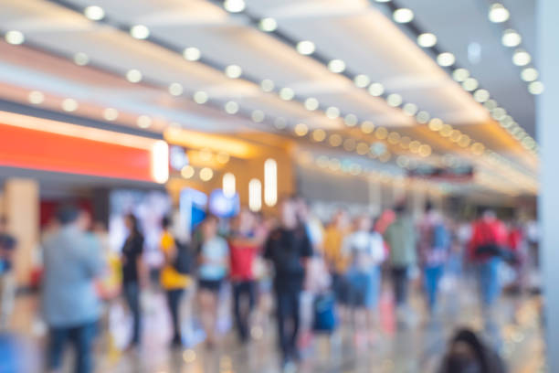 Blurred,defocused background of Crowd in trade event exhibition hall. Business trade show,shopping mall and marketing advertisement concept,MICE industry business concept stock photo