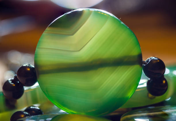 istock Large polished beads of beautiful translucent green agate gemstone, macro 1153317979